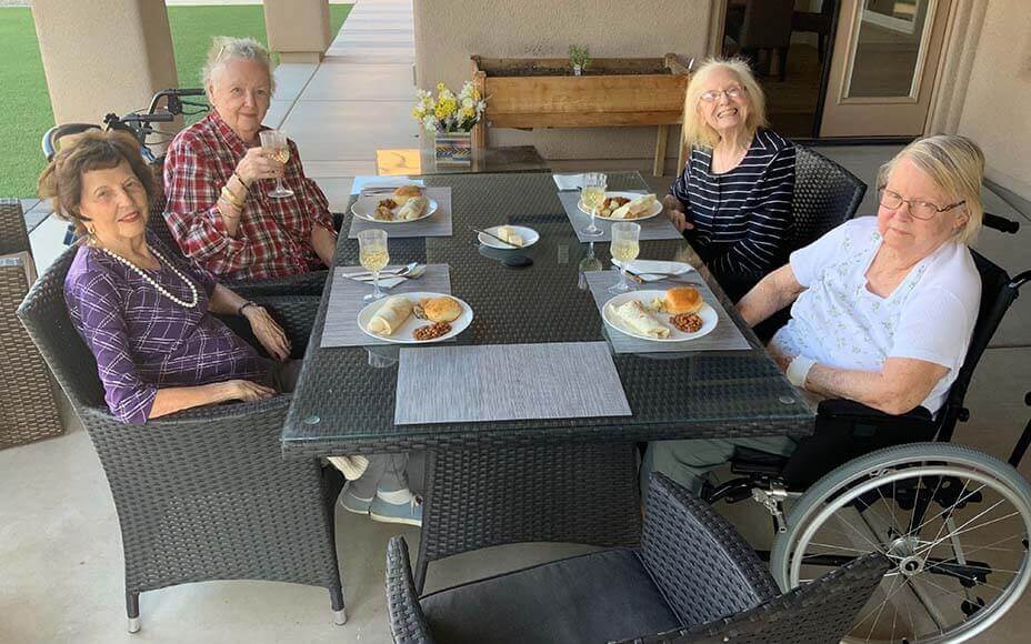 A group of four seniors having lunch at the back of Valencia