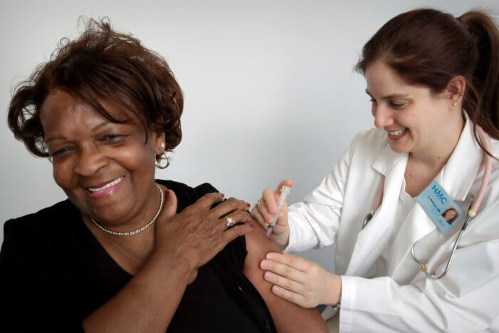 A medical expert giving a Covid 19 Vaccine