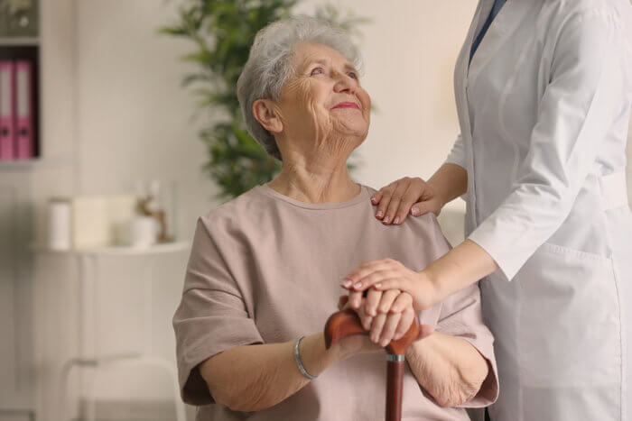 a senior happily looking at the doctor