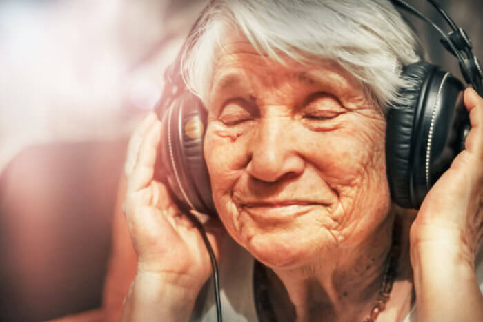a senior listening to music in a headphone